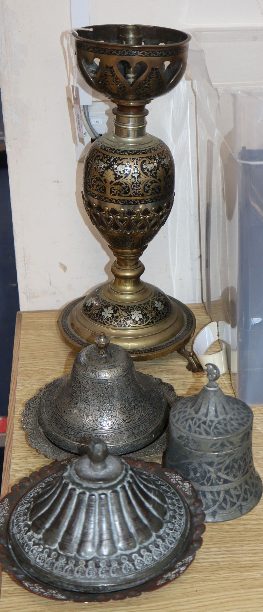 Three Indo-Persian tinned lidded dishes and a brass huqqa base table lamp, largest 43.5cm